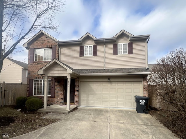 view of front of home featuring a garage, fence, concrete driveway, and brick siding