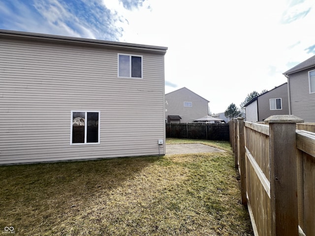 view of side of property featuring a patio and a yard