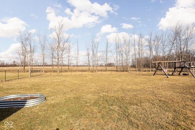 view of yard with a rural view and a playground