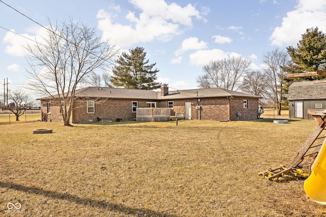 back of property featuring a yard and a storage shed