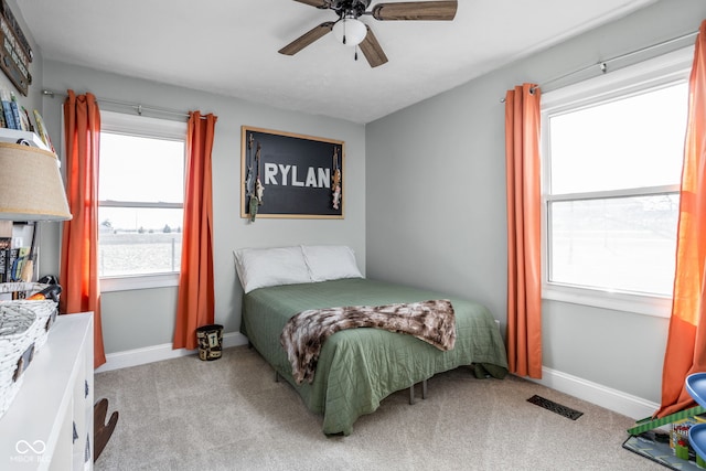 bedroom with light carpet and ceiling fan