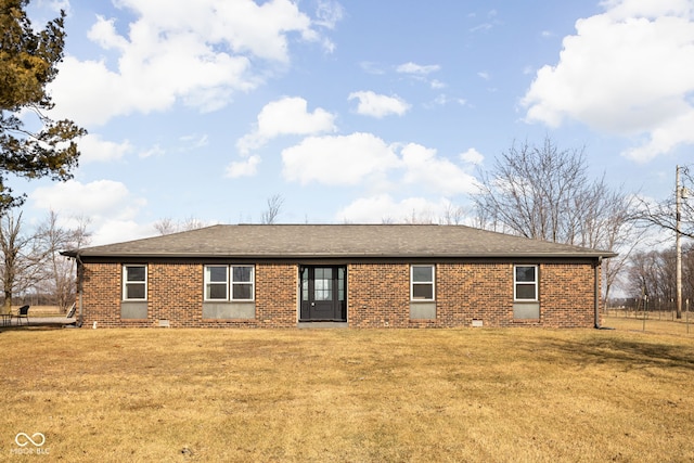 back of property featuring a lawn