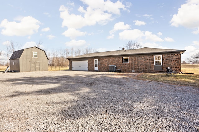 view of home's exterior with an outdoor structure and central air condition unit