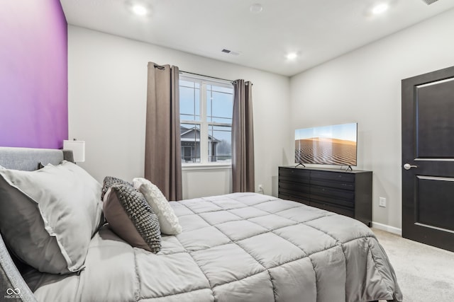 bedroom featuring light colored carpet