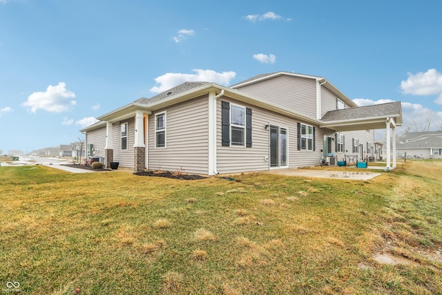 back of house featuring central AC unit, a yard, and a patio