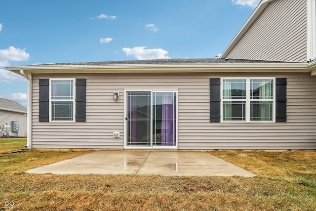 back of property with a patio area and a lawn