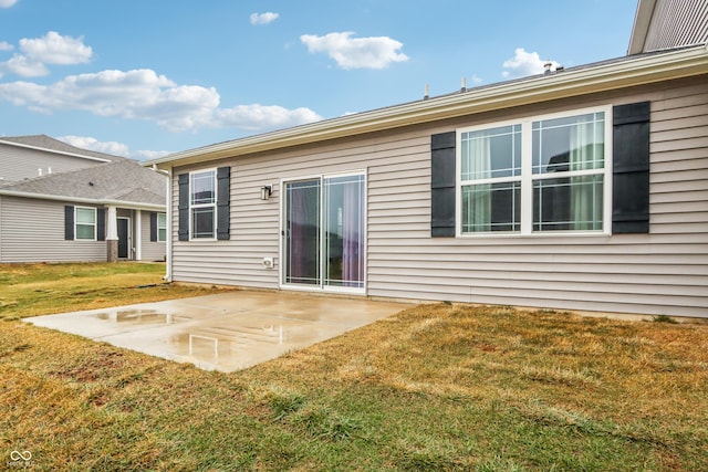 rear view of house with a yard and a patio area