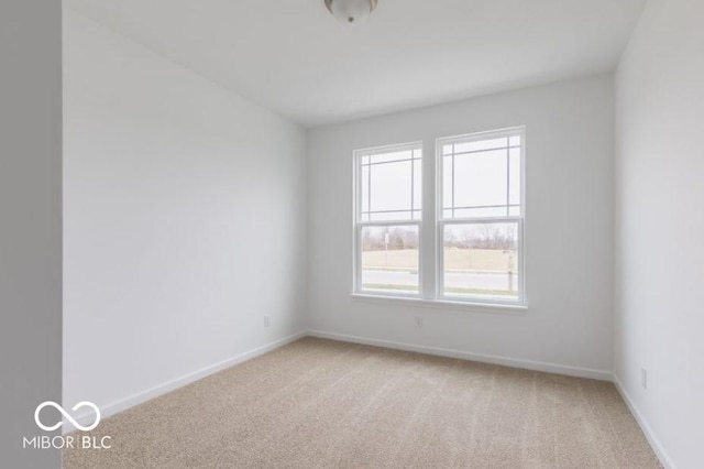 empty room with light carpet and baseboards