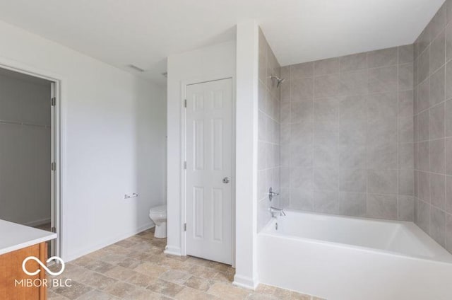 full bathroom featuring shower / tub combination, toilet, vanity, baseboards, and a closet