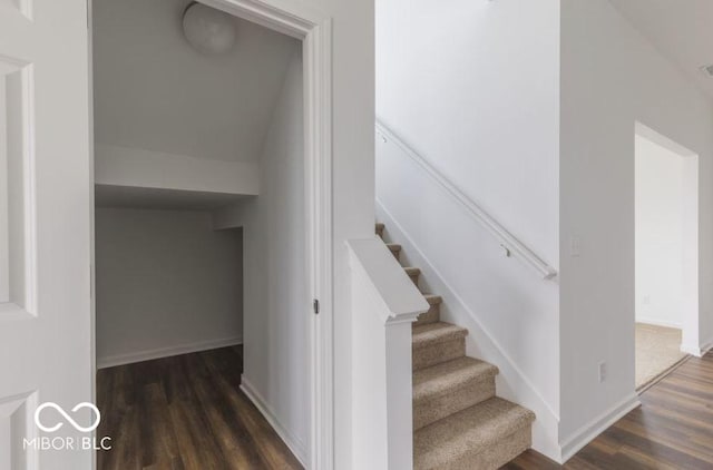 stairs with visible vents, baseboards, and wood finished floors