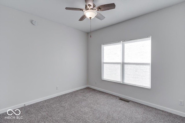 carpeted spare room with ceiling fan