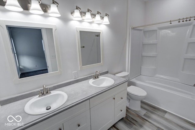 full bathroom with bathing tub / shower combination, hardwood / wood-style floors, vanity, and toilet