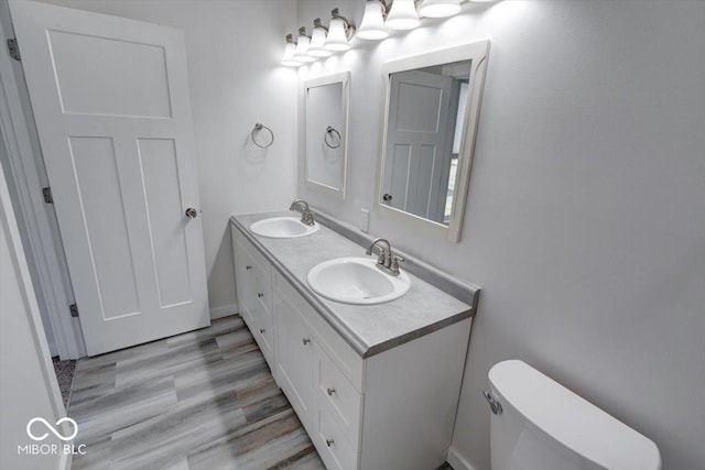 bathroom featuring vanity, toilet, and hardwood / wood-style floors