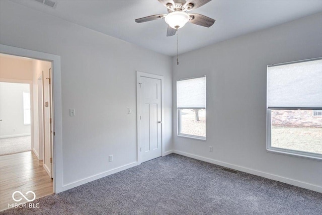 interior space with ceiling fan and carpet