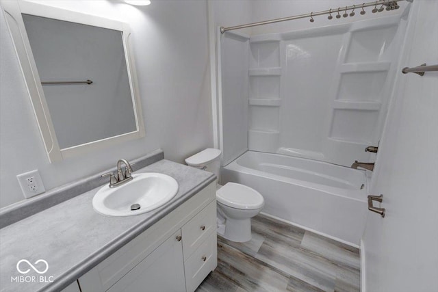 full bathroom with vanity, hardwood / wood-style flooring, shower / tub combination, and toilet