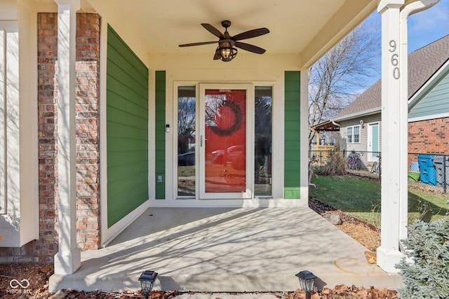 doorway to property with ceiling fan and a patio area