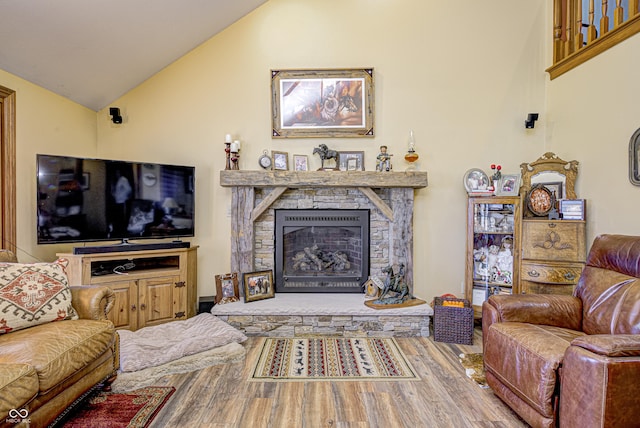 living room featuring a fireplace, wood-type flooring, and lofted ceiling