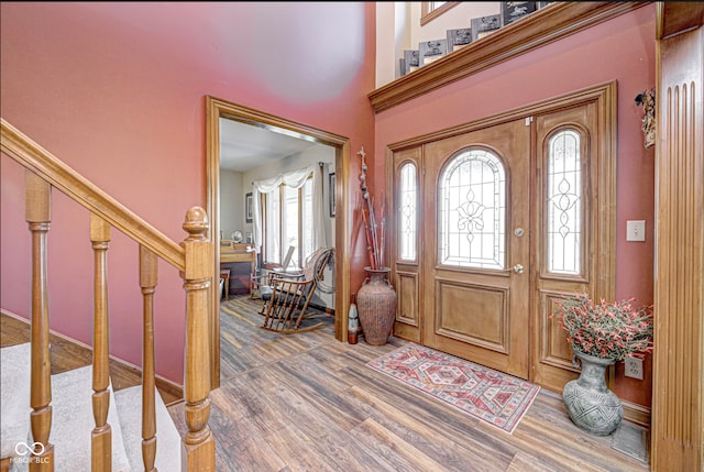 entrance foyer with stairs and wood finished floors