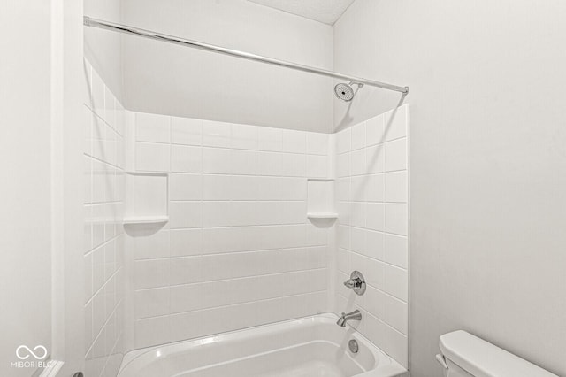 bathroom featuring tub / shower combination and toilet