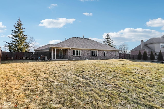 rear view of house featuring a yard