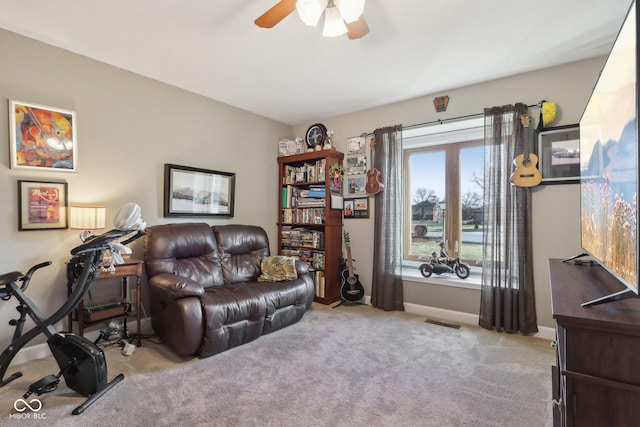 living room featuring ceiling fan and light colored carpet