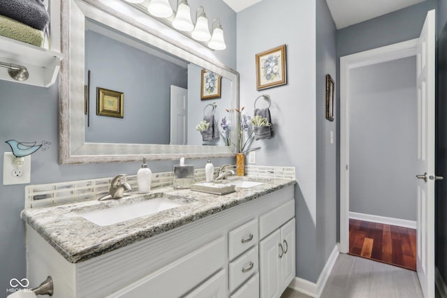 bathroom with hardwood / wood-style flooring and vanity