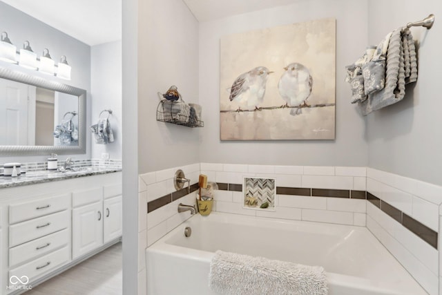 bathroom featuring vanity and a washtub