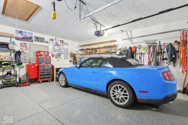 garage featuring a garage door opener and electric panel