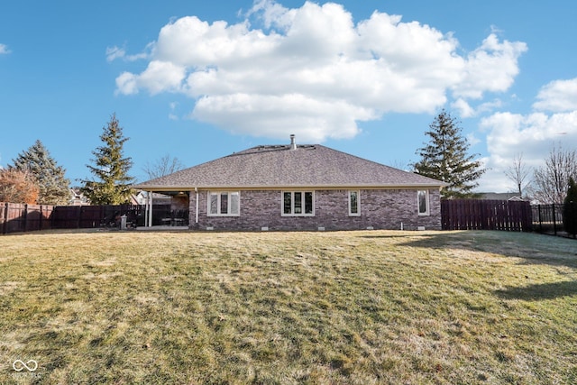 rear view of property with a lawn