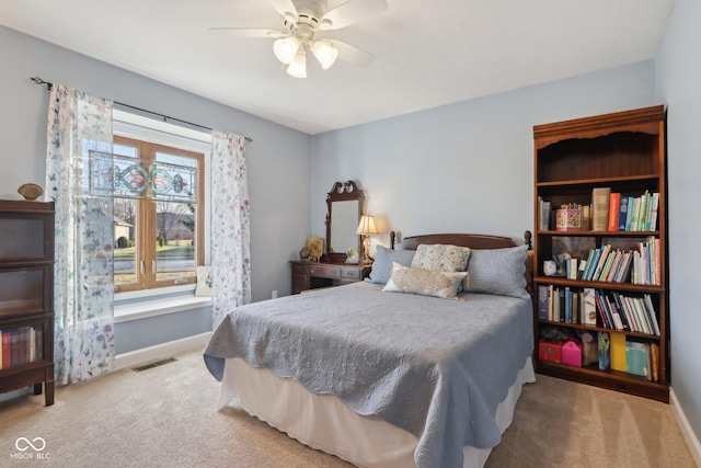 bedroom featuring light carpet and ceiling fan