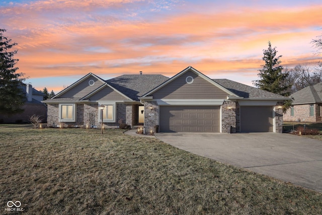 view of front of property with a garage and a yard