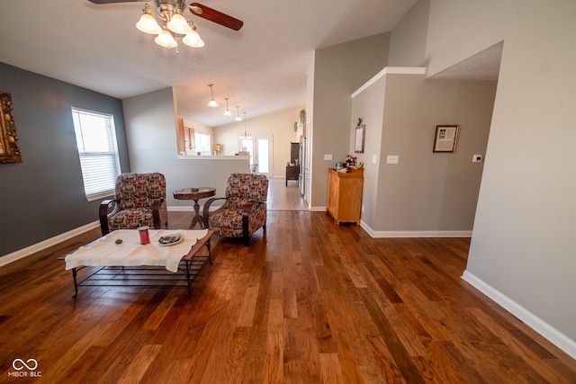 living area with lofted ceiling, dark hardwood / wood-style floors, and ceiling fan