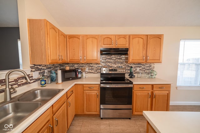 kitchen with lofted ceiling, sink, tasteful backsplash, light tile patterned floors, and electric stove