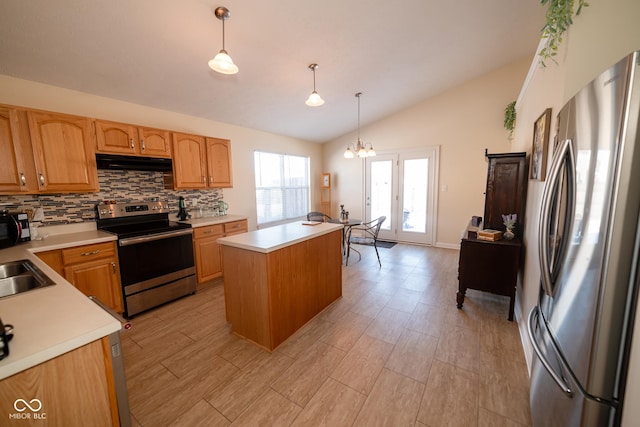 kitchen with hanging light fixtures, decorative backsplash, a center island, and appliances with stainless steel finishes