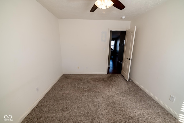 empty room featuring carpet floors and ceiling fan