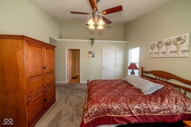 carpeted bedroom featuring ceiling fan and high vaulted ceiling