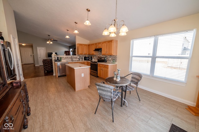 kitchen with backsplash, stainless steel appliances, a kitchen island, decorative light fixtures, and exhaust hood