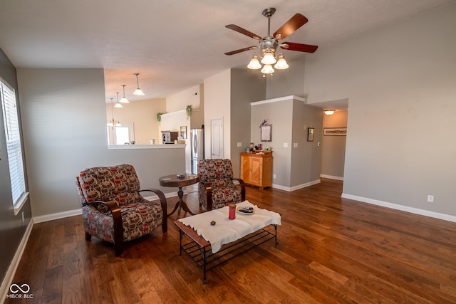 sitting room with dark hardwood / wood-style flooring, lofted ceiling, and ceiling fan