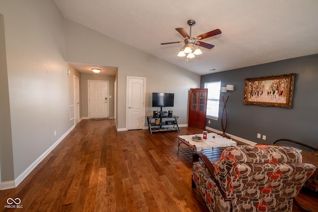 unfurnished living room featuring ceiling fan, dark hardwood / wood-style floors, and vaulted ceiling