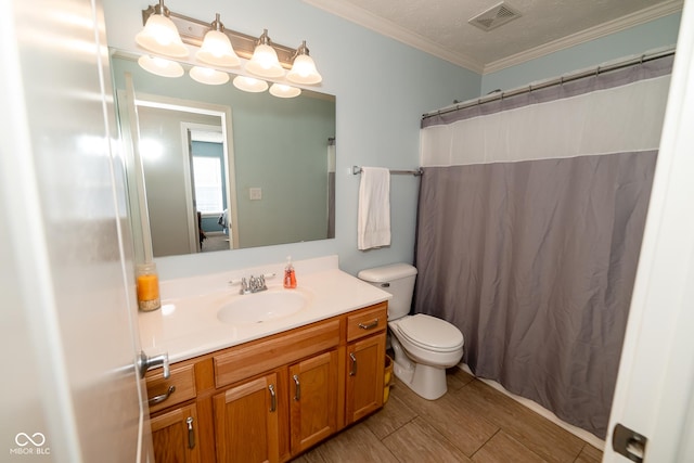 bathroom featuring crown molding, vanity, and toilet