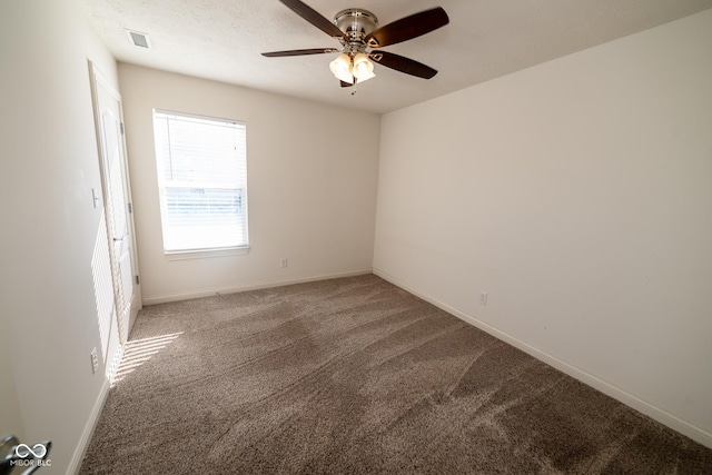 spare room featuring a textured ceiling, carpet floors, and ceiling fan