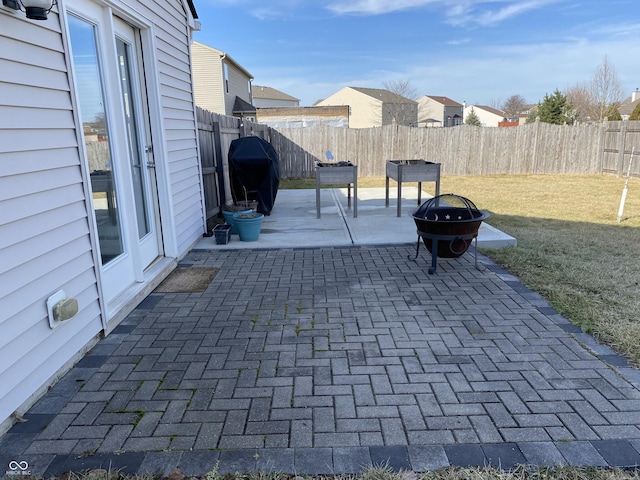 view of patio with a grill and an outdoor fire pit