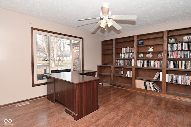 office area featuring visible vents, a textured ceiling, and wood finished floors