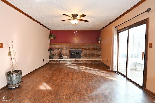 unfurnished living room featuring wood-type flooring, ornamental molding, ceiling fan, and a textured ceiling