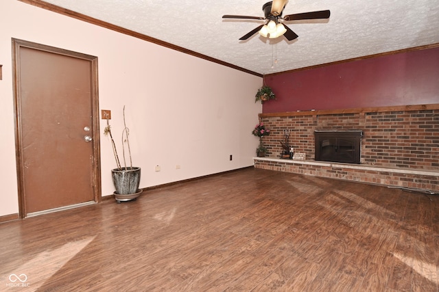 unfurnished living room with hardwood / wood-style floors, a fireplace, ornamental molding, ceiling fan, and a textured ceiling