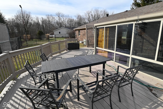 deck featuring outdoor dining area and fence