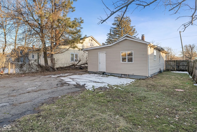 rear view of property with a lawn