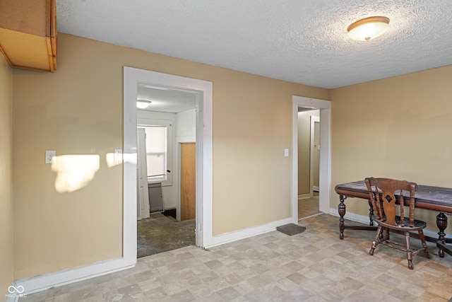 interior space with a textured ceiling