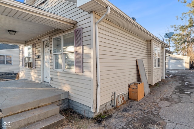 view of home's exterior featuring an outbuilding, cooling unit, and a garage