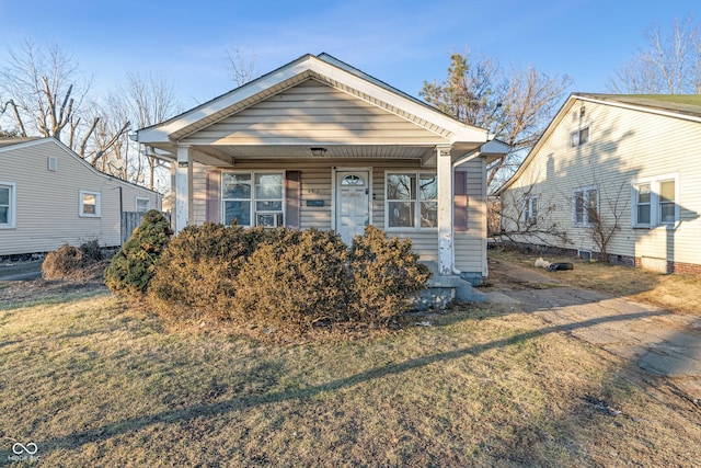 bungalow-style house featuring a front yard and covered porch